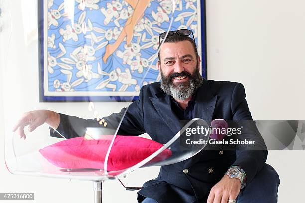 Artist Mauro Bergonzoli and his love chair during the Mauro Bergonzoli Country Life Studio Opening on May 30, 2015 in Kirchheim, Germany.