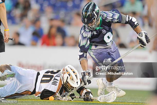 John Ortolani#30 of the Rochester Rattlers and CJ Costabile of the Chesapeake Bayhawks fight for a loss ball during a MLL lacrosse game against the...