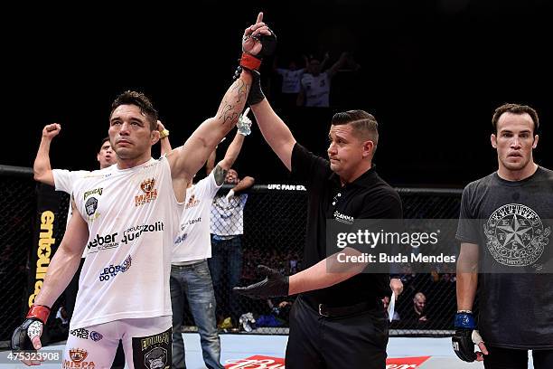 Rony Jason of Brazil celebrates victory by submission over Damon Jackson of the United States in their UFC featherweight bout during the UFC Fight...