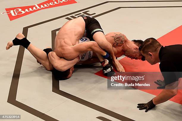 Rony Jason of Brazil submits Damon Jackson of the United States in their UFC featherweight bout during the UFC Fight Night Condit v Alves at Arena...