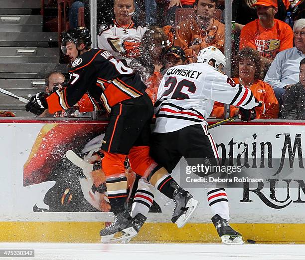 Rickard Rakell of the Anaheim Ducks battles for position against Kyle Cumiskey of the Chicago Blackhawks in Game Seven of the Western Conference...