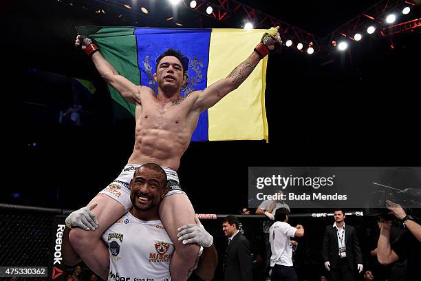 Rony Jason of Brazil celebrates victory by submission over Damon Jackson of the United States in their UFC featherweight bout during the UFC Fight...