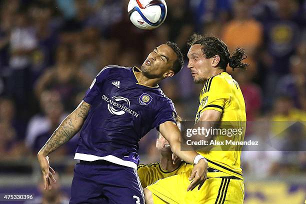 Seb Hines of Orlando City SC and Emanuel Pogatetz of Columbus Crew fight to head the ball during a MLS soccer match between the Columbus Crew and the...
