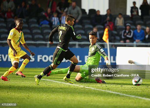 Dieudonne Gbakle of Mali shoots past Mexican goalkeeper Raul Gudino to score during the FIFA U-20 World Cup New Zealand 2015 Group D match between...