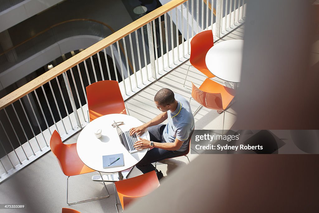 Businessman working on laptop in cafe