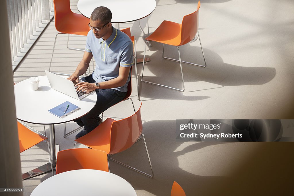Businessman working on laptop in cafe