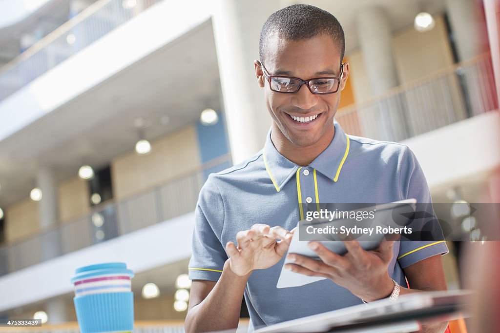 Businessman using digital tablet in cafe