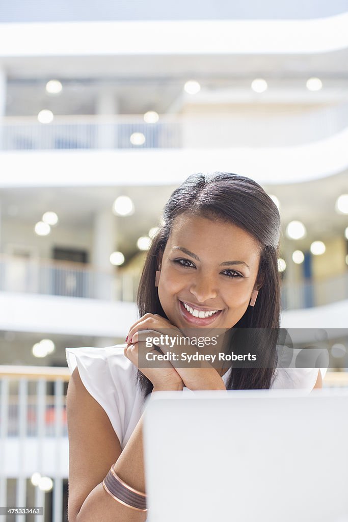 Businesswoman using laptop in cafe