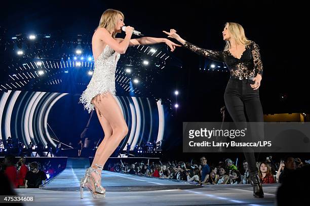 Musician Taylor Swift and model Gigi Hadid perform on stage during the 1989 World Tour Live at Ford Field on May 30, 2015 in Detroit, Michigan.