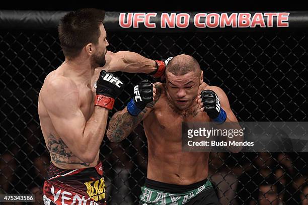 Carlos Condit of the United States punches Thiago Alves of Brazil in their welterweight UFC bout during the UFC Fight Night event at Arena Goiania on...