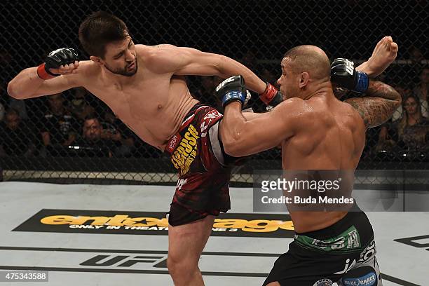 Carlos Condit of the United States kicks Thiago Alves of Brazil in their welterweight UFC bout during the UFC Fight Night event at Arena Goiania on...