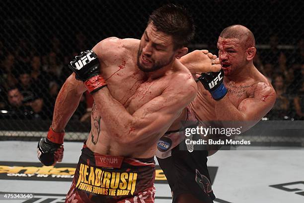 Thiago Alves of Brazil kicks Carlos Condit of the United States in their welterweight UFC bout during the UFC Fight Night event at Arena Goiania on...