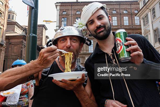 Two boys during the event Noodles standing. Eating he protests against those who try to destroy the man and his rights, proclaiming freedom of...