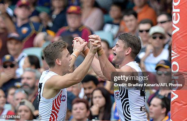 Maverick Weller of the Saints celebrates with team mates Jack Lonie after kicking a goal during the round nine AFL match between the Brisbane Lions...