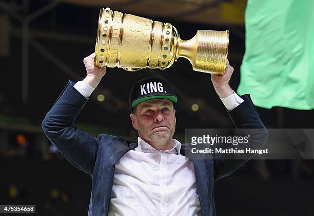 Head coach Dieter Hecking of VfL Wolfsburg celebrates with the trophy after his teams victory in the DFB Cup Final match between Borussia Dortmund...
