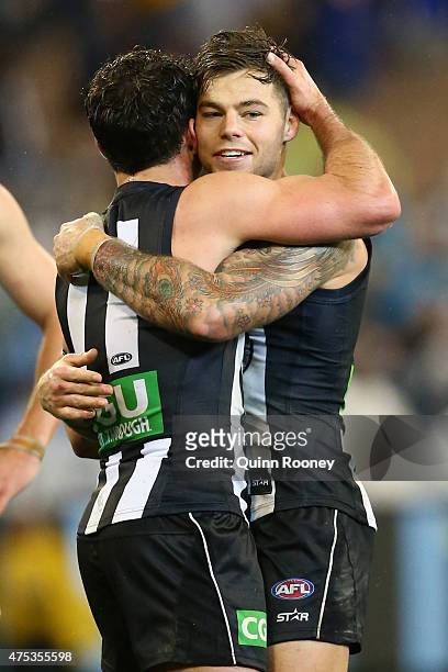 Jamie Elliott of the Magpies is congratulated by Jarryd Blair after kicking a goal during the round nine AFL match between the Collingwood Magpies...