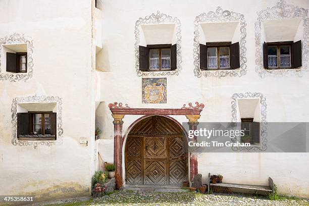 House in the Engadine Valley in the village of Guarda with old painted stone 17th Century buildings, Switzerland