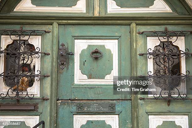Door in Engadine Valley village of Guarda with old painted stone 17th Century buildings, Switzerland
