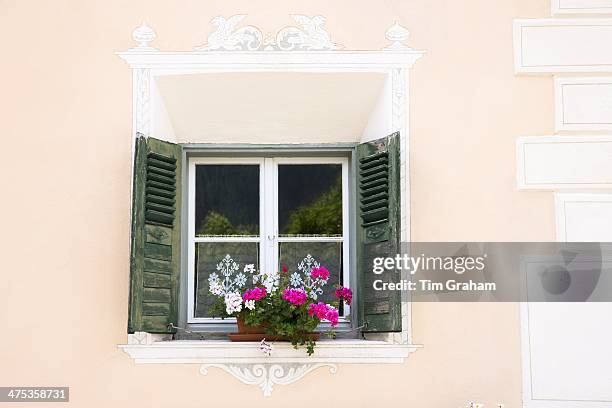 Detail of window in the Engadine Valley in village of Guarda with old painted stone 17th Century houses, Switzerland