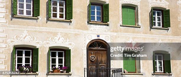House in the Engadine Valley in the village of Guarda with old painted stone 17th Century buildings, Switzerland