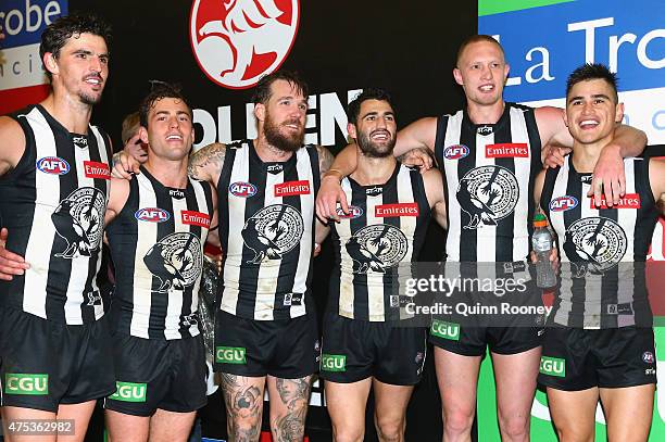 Scott Pendlebury, Jarryd Blair, Dane Swan, Jamie Elliott, Jack Frost and Marley Williams of the Magpies sing the song in the rooms after winning the...