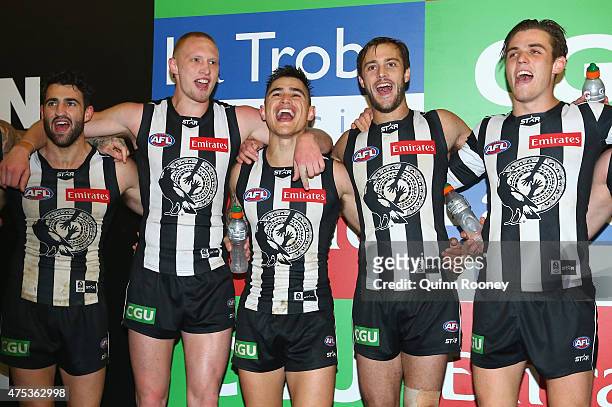 Alex Fasolo, Jack Frost, Marley Williams, Alan Toovey and Paul Seedsman of the Magpies sing the song in the rooms after winning the round nine AFL...