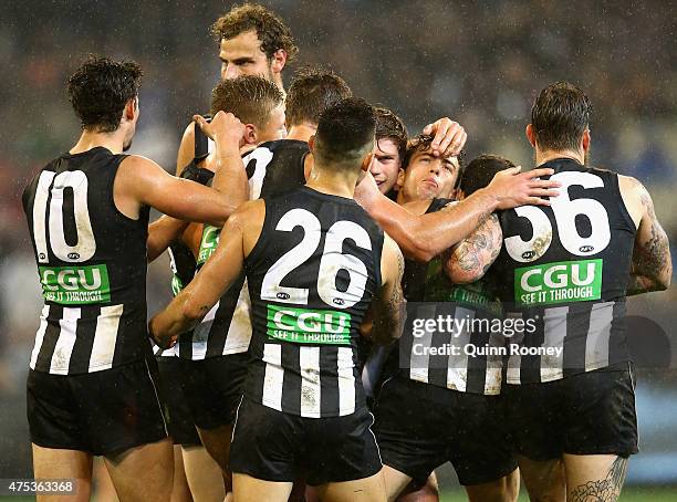 Jarryd Blair of the Magpies is congratulated by team mates after kicking a goal during the round nine AFL match between the Collingwood Magpies and...