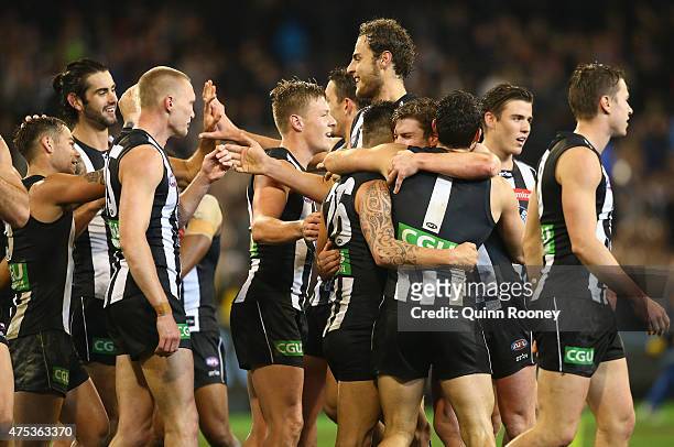 Magpies players celebrate winning the round nine AFL match between the Collingwood Magpies and the North Melbourne Kangaroos at Melbourne Cricket...