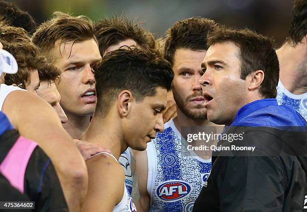 Brad Scott the coach of the Kangaroos talks to his players during the round nine AFL match between the Collingwood Magpies and the North Melbourne...