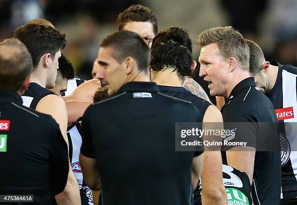 Nathan Buckley the coach of the Magpies talks to his players during the round nine AFL match between the Collingwood Magpies and the North Melbourne...