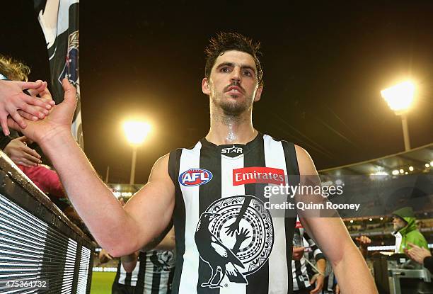 Scott Pendlebury of the Magpies high fives fans after winning the round nine AFL match between the Collingwood Magpies and the North Melbourne...