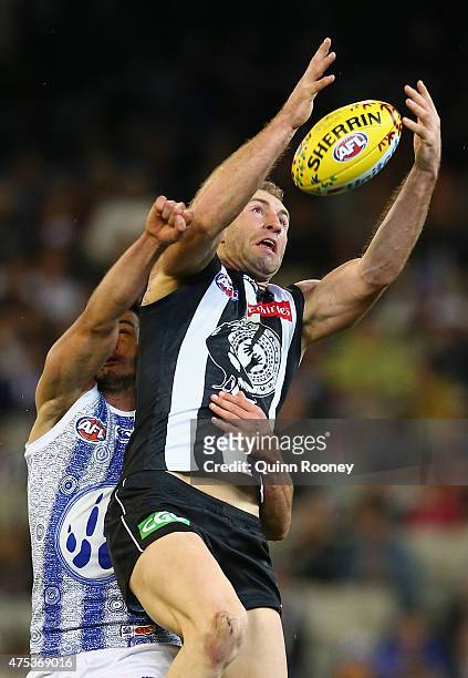 Travis Cloke of the Magpies marks infront of Robbie Tarrant of the Kangaroos during the round nine AFL match between the Collingwood Magpies and the...