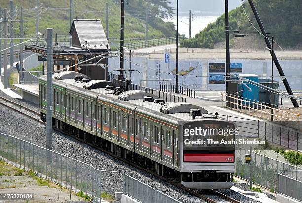 Test train runs past new Tona station on May 29, 2015 in Higashimatsushima, Miyagi, Japan. After a more than four-year wait, the tsunami-hit JR...