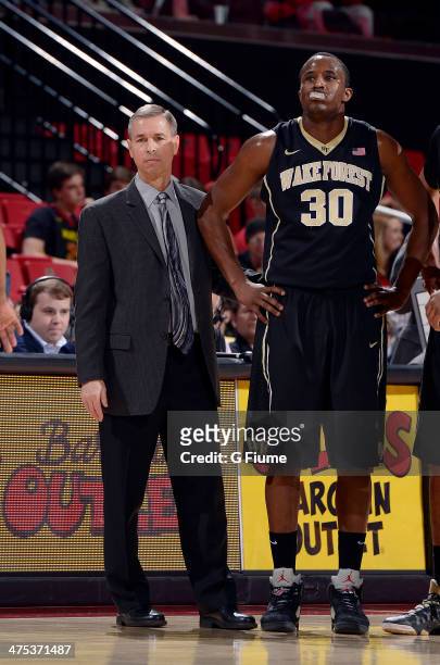 Head coach Jeff Bzdelik of the Wake Forest Demon Deacons talks with Travis McKie during the game against the Maryland Terrapins at the Comcast Center...