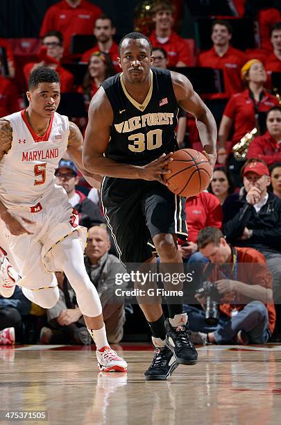 Travis McKie of the Wake Forest Demon Deacons handles the ball against the Maryland Terrapins at the Comcast Center on February 18, 2014 in College...