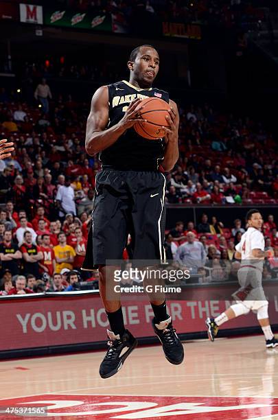 Travis McKie of the Wake Forest Demon Deacons grabs a rebound against the Maryland Terrapins at the Comcast Center on February 18, 2014 in College...