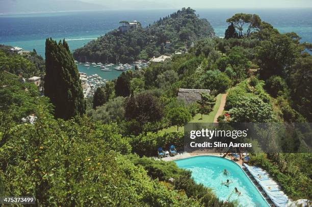 Guests by the pool at Klaus Pudel's villa, the Casa Montefino, overlooking Portofino harbour, Portofino, Italy, August 1977.