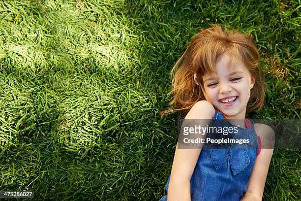laughing little cutie! - reclining stockfoto's en -beelden