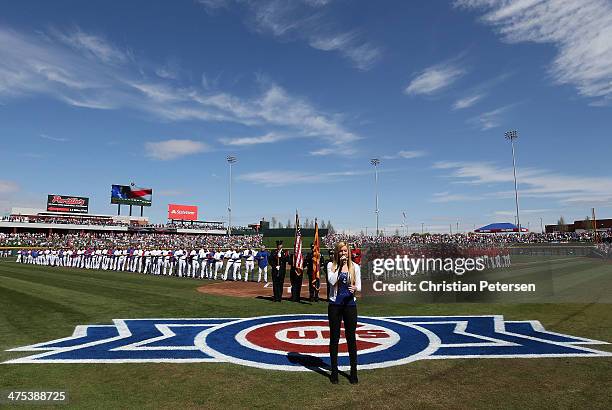 Michelle Moyer performs the National Anthem before the spring training game between the Chicago Cubs and the Arizona Diamondbacks at Cubs Park on...