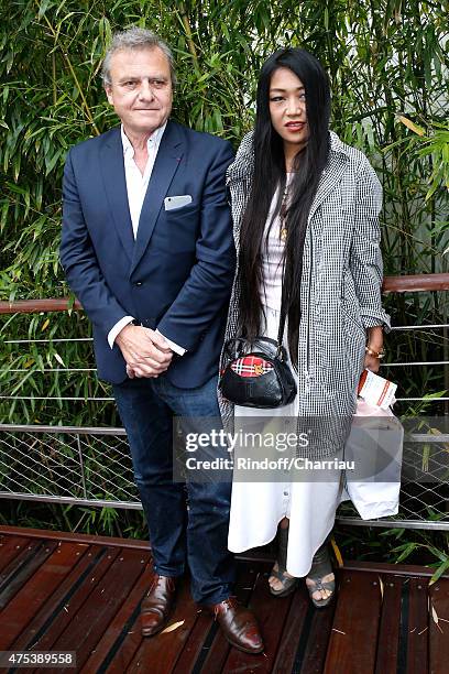 Fashion Designer, Jean-Charles de Castelbajac and his companion Jewelry Designer, Ai Canno attend the 2015 Roland Garros French Tennis Open - Day...