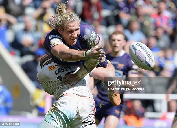 Remi Casty of Catalans Dragons tackles Eorl Crabtree of Huddersfield Giants during the Super League match between Catalans Dragons and Huddersfield...