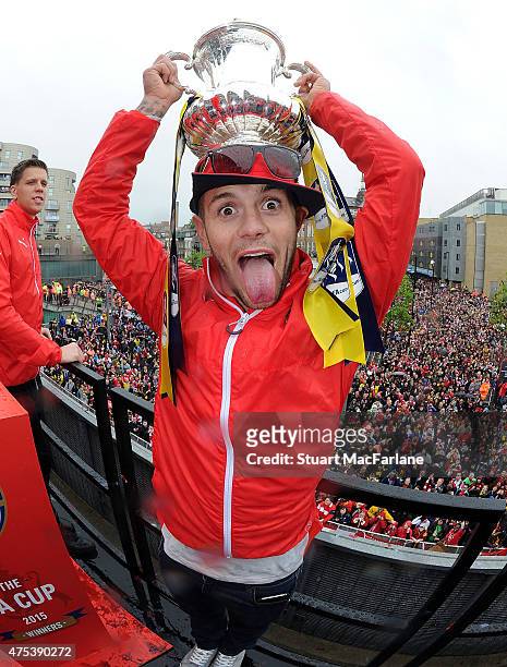 Arsenal's Jack Wilshere poses with the cup during the Arsenal FA Cup Victory Parade in Islington on May 31, 2015 in London, England.