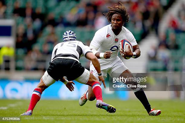 Marland Yarde of England is tackled by Gio Aplon of Barbarians during the England XV v Barbarians match at Twickenham Stadium on May 31, 2015 in...
