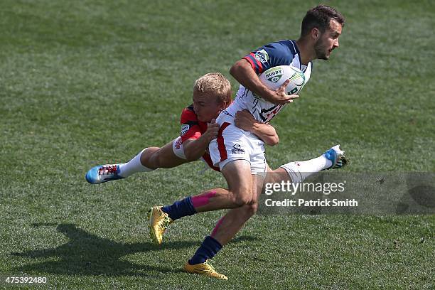 Anthony Spencer of Arizona is tackled by Glenn Erikson of Arkansas State in the Cup Quarter Final during Day 2 of the Penn Mutual Collegiate Rugby...