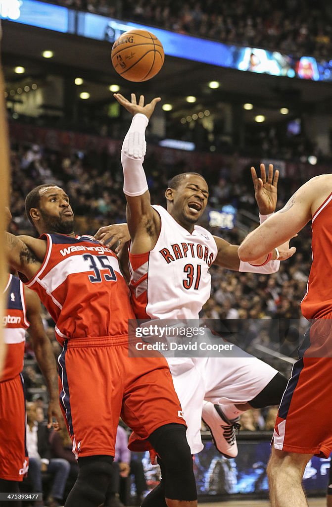 Toronto Raptors small forward Terrence Ross (31) has a painful landing in the paint against Washington Wizards power forward Trevor Booker (35)