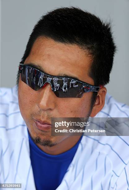 Pitcher Kyuji Fujikawa of the Chicago Cubs watches from the duogut during the spring training game against the Arizona Diamondbacks at Cubs Park on...