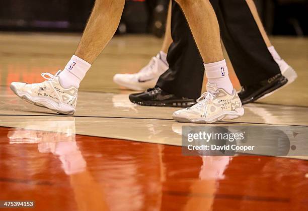 Toronto Raptors point guard Greivis Vasquez wears basketball shoes that he has written messages on during the game between the Toronto Raptors and...