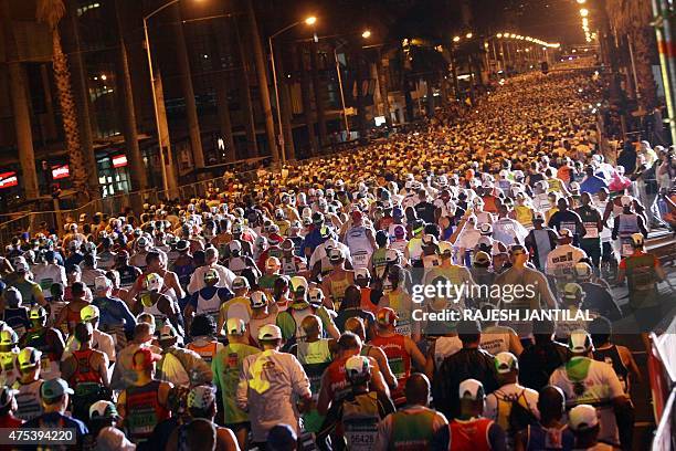 Runners take on May 31,2015 the start of the 89km of the 90th Comrades Marathon between Durban and Pietermaritzburg in Durban. The annual ultra...