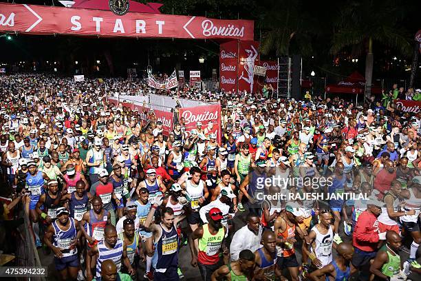 Runners take on May 31,2015 the start of during the 89km of the 90th Comrades Marathon between Durban and Pietermaritzburg in Durban. The annual...