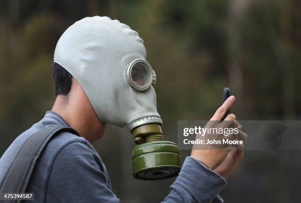 An anti-government protester checks his smart phone during a demonstration on February 27, 2014 in Caracas, Venezuela. Almost three weeks after...